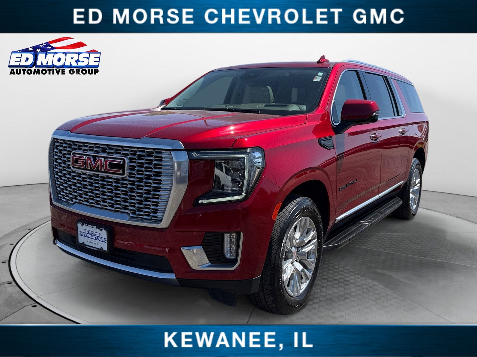 2023 GMC Yukon XL Denali in Volcanic Red Tintcoat — front three-quarter view